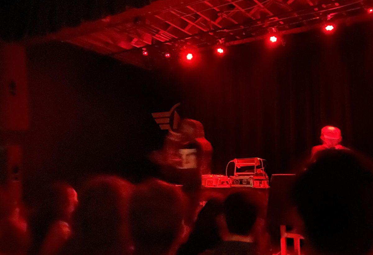 billy woods and Kenny Segal performing a song at Motorco Music Hall in Durham, NC under dim red lighting